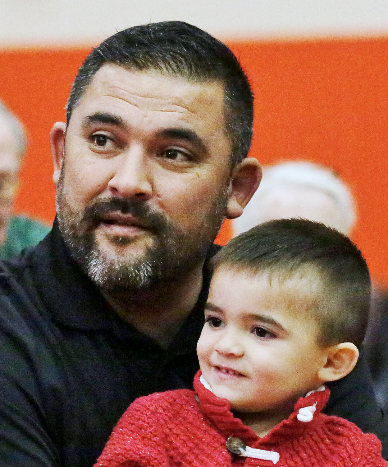 Former active duty Marine Kris Quintana and his son, River, enjoyed the Veterans Day program in the Mineola School gymnasium.